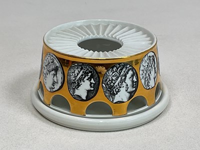 Lot 237 - FORNASETTI; a teapot warmer and stand,...