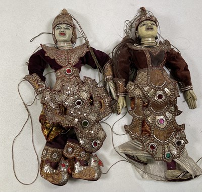 Lot 389 - Two Asian wooden puppets with sequin dresses,...