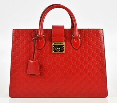 Lot 641 - GUCCI; a red calfskin embossed GG monogram...