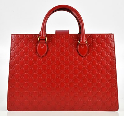 Lot 641 - GUCCI; a red calfskin embossed GG monogram...