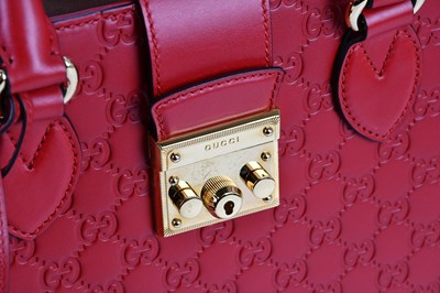 Lot 641 - GUCCI; a red calfskin embossed GG monogram...