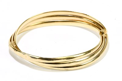 Lot 1268 - A 9ct yellow gold adjustable ribbed hinged...