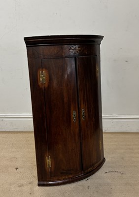 Lot 1062 - A Georgian inlaid mahogany bowfront hanging...