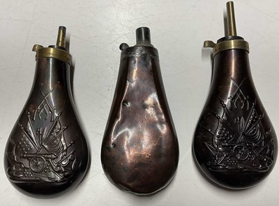 Lot 95 - Three copper and brass powder and shot flasks,...