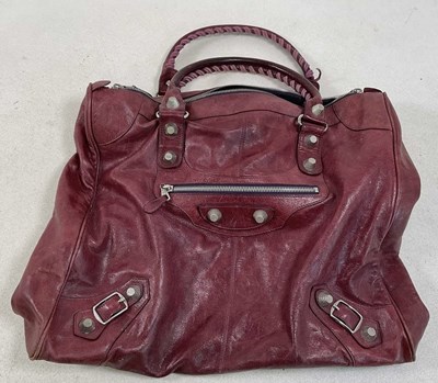 Lot 166 - BALENCIAGA; a large burgundy leather tote bag,...