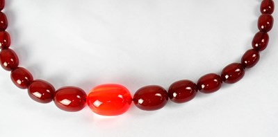 Lot 1090 - A cherry amber style graduated bead necklace,...