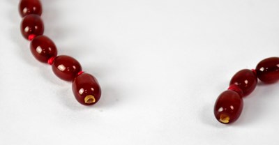 Lot 1090 - A cherry amber style graduated bead necklace,...