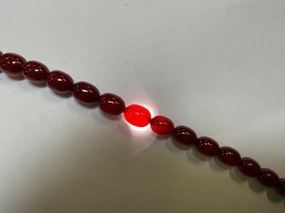 Lot 1090 - A cherry amber style graduated bead necklace,...
