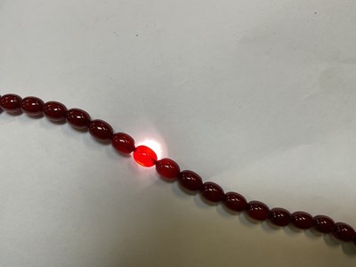 Lot 1090 - A cherry amber style graduated bead necklace,...