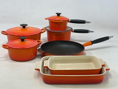 Lot 197 - LE CREUSET; a Volcanic Orange cast iron round...