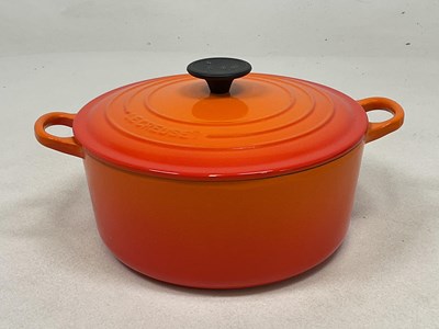 Lot 197 - LE CREUSET; a Volcanic Orange cast iron round...
