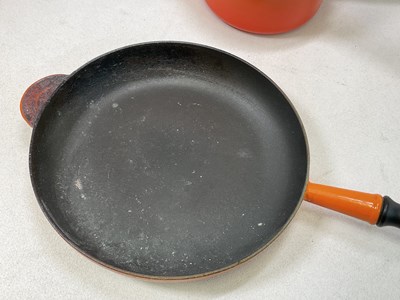 Lot 197 - LE CREUSET; a Volcanic Orange cast iron round...