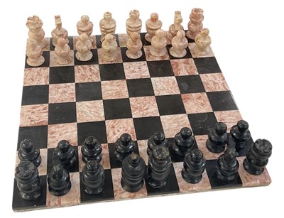 Lot 303 - A modern black and rouge Mexican onyx chess...