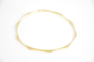Lot 223 - A 14ct yellow gold fixed bangle, internal...