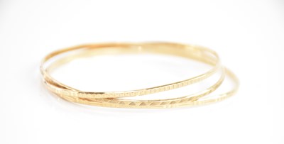 Lot 231 - Three 9ct yellow gold bangles, combined approx...