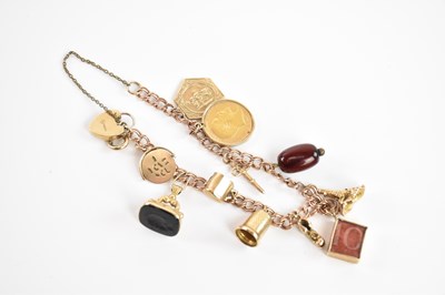 Lot 225 - A 9ct gold charm bracelet, set with several...