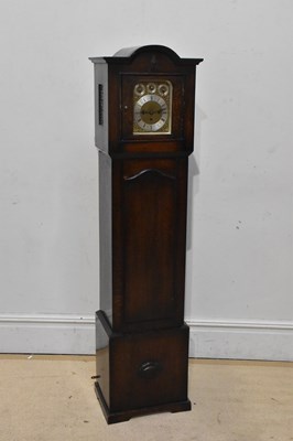 Lot 277 - A 1920s oak granddaughter clock with brass...