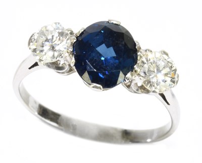 Lot 1009 - An 18ct white gold sapphire and diamond ring,...