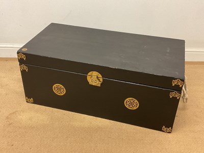 Lot 380 - A Chinese black painted wooden trunk with rope...