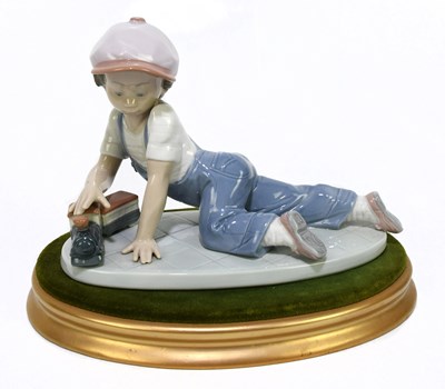 Lot 525 - LLADRO; a figure of a boy with a train 'All...