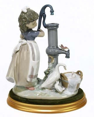 Lot 510 - LLADRO; a figure of a girl by a water pump...