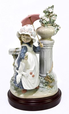 Lot 514 - LLADRO; a figure of a girl with a parasol...