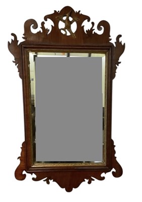 Lot 49 - A Georgian fret carved wall mirror, surmounted...