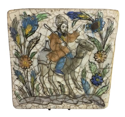 Lot 561 - An early 20th century Persian tin glazed tile,...