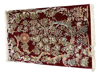 Lot 63 - A fine Persian silk red ground Qum carpet,...