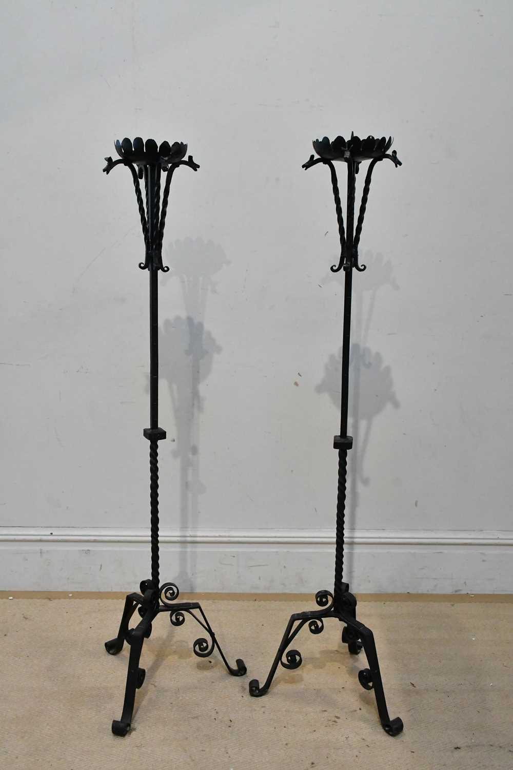 Lot 2408 - A pair of wrought iron pricket candle stands...