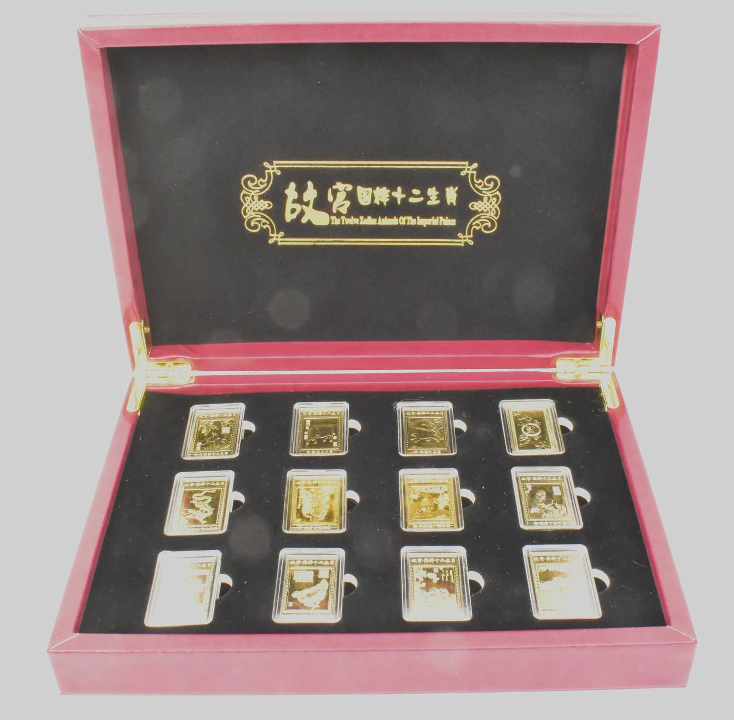 Lot 1569 - A cased set of twelve gold plated ingots to...