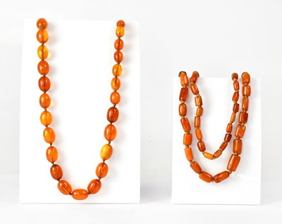 Lot 1092 - Two continuous amber-style necklaces, one with...
