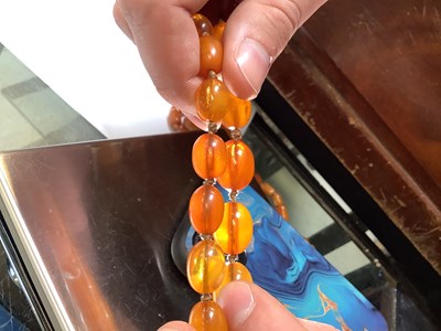 Lot 1092 - Two continuous amber-style necklaces, one with...