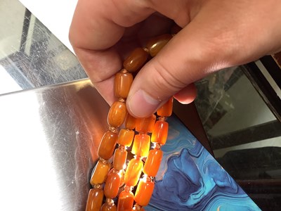 Lot 1092 - Two continuous amber-style necklaces, one with...