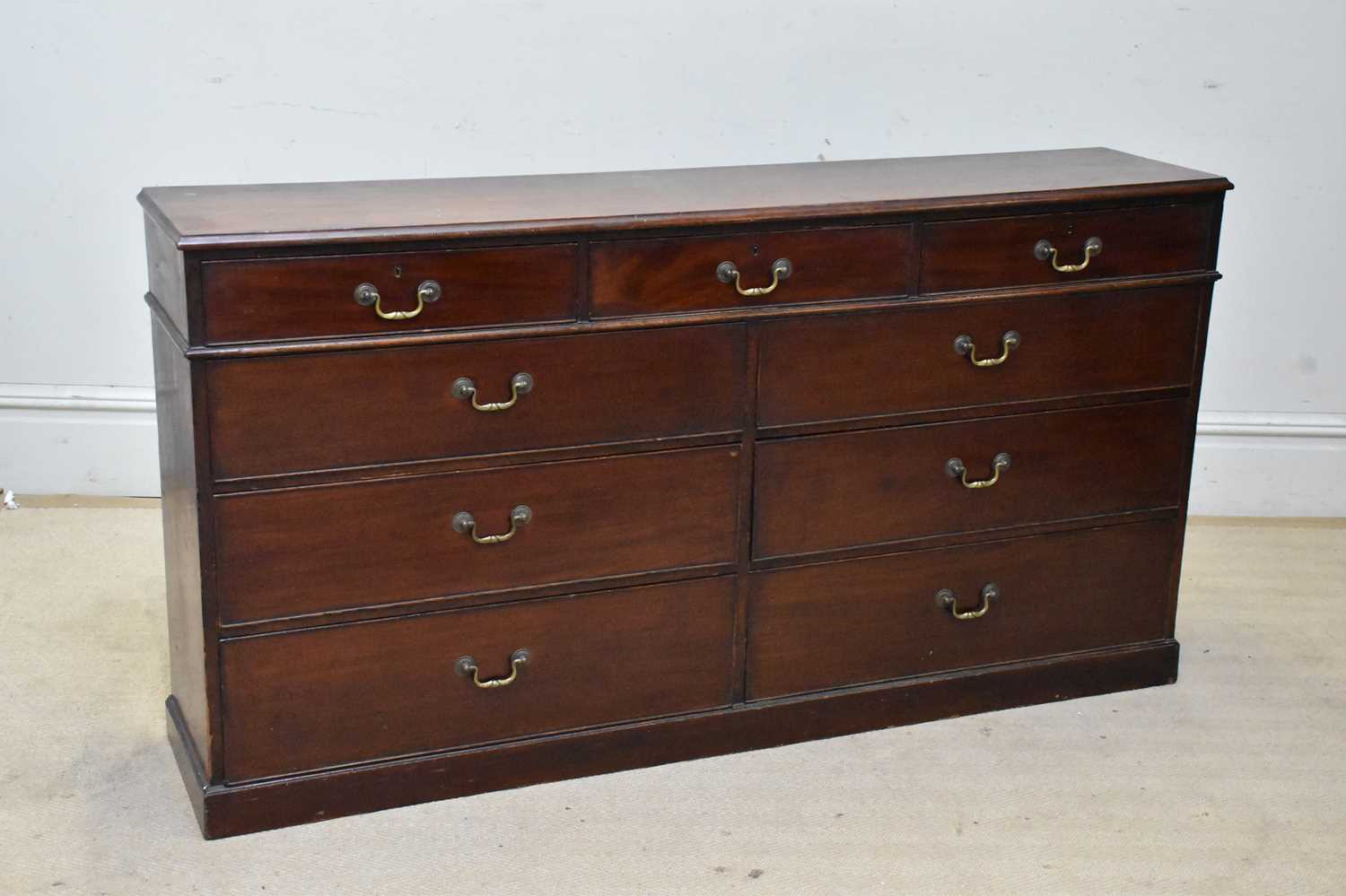 Lot 2147 - A mahogany chest of nine assorted drawers, on...