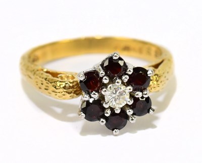 Lot 1134 - An 18ct yellow gold diamond centred flower...