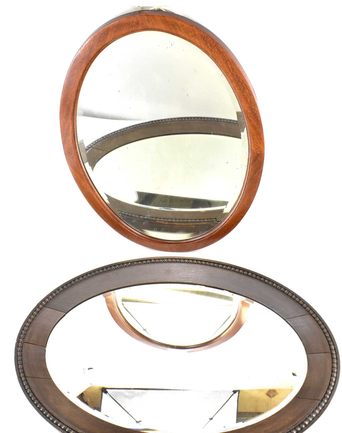 Lot 80 A dark oak framed oval bevel edge mirror,