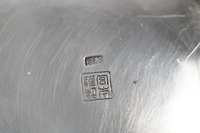 Lot 276 - Two Japanese silver sake dishes, one raised on...