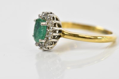 Lot 100 - An 18ct yellow gold diamond and emerald oval...