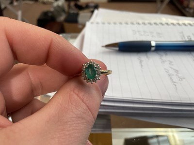 Lot 100 - An 18ct yellow gold diamond and emerald oval...