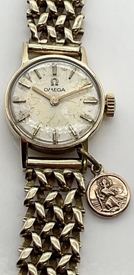 Lot 582 - OMEGA; a lady's vintage 9ct gold wristwatch...