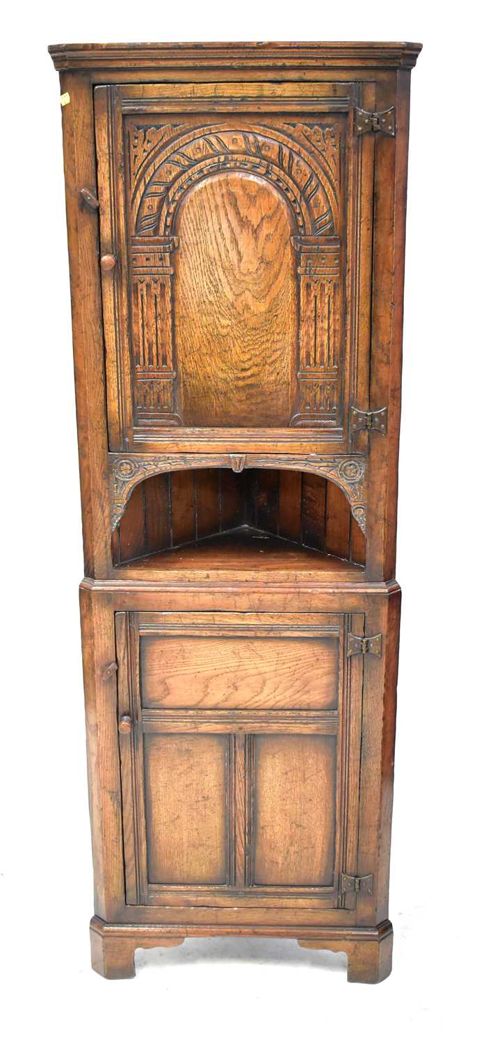 Lot 42 - A small reproduction oak corner cabinet in the...