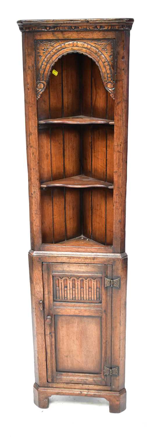 Lot 48 - A reproduction oak corner unit in the manner...