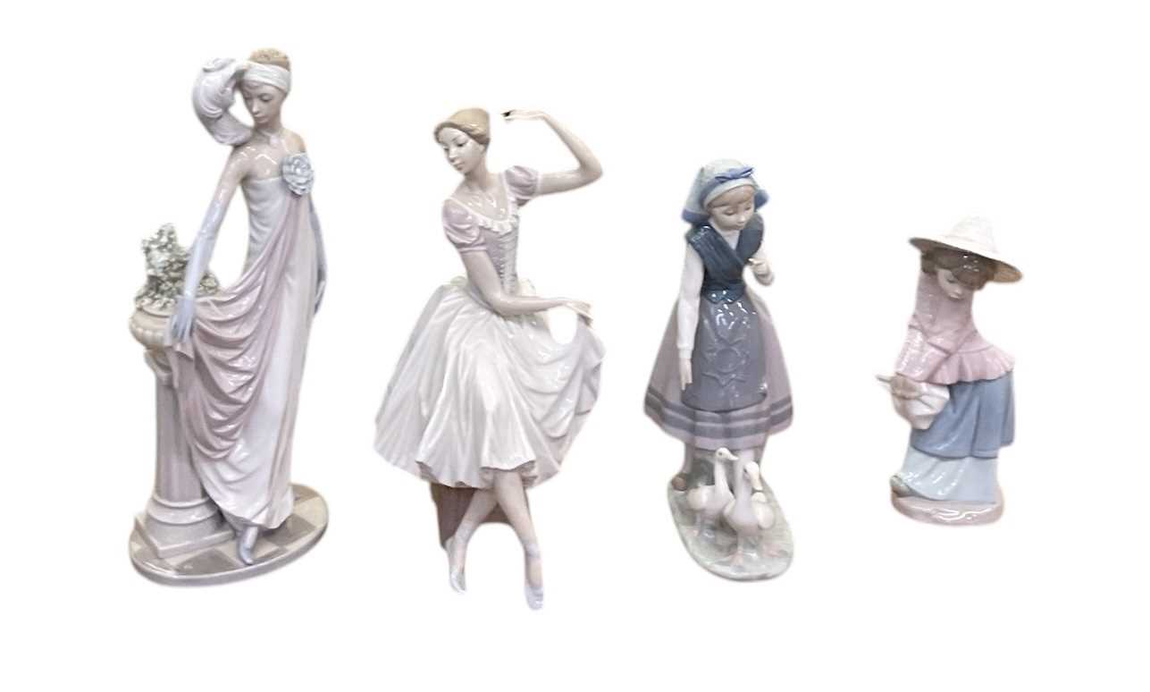 Lot 645 - LLADRÓ; three porcelain figures of ladies...