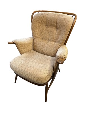 Lot 37 - ERCOL; a set of three medium elm spindle back...