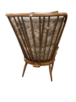 Lot 37 - ERCOL; a set of three medium elm spindle back...