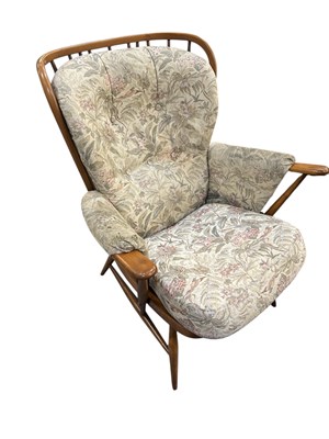 Lot 37 - ERCOL; a set of three medium elm spindle back...