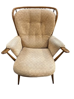 Lot 37 - ERCOL; a set of three medium elm spindle back...