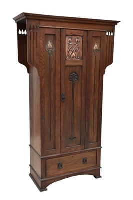 Lot 1009 - An Arts and Crafts carved oak hall robe in the...