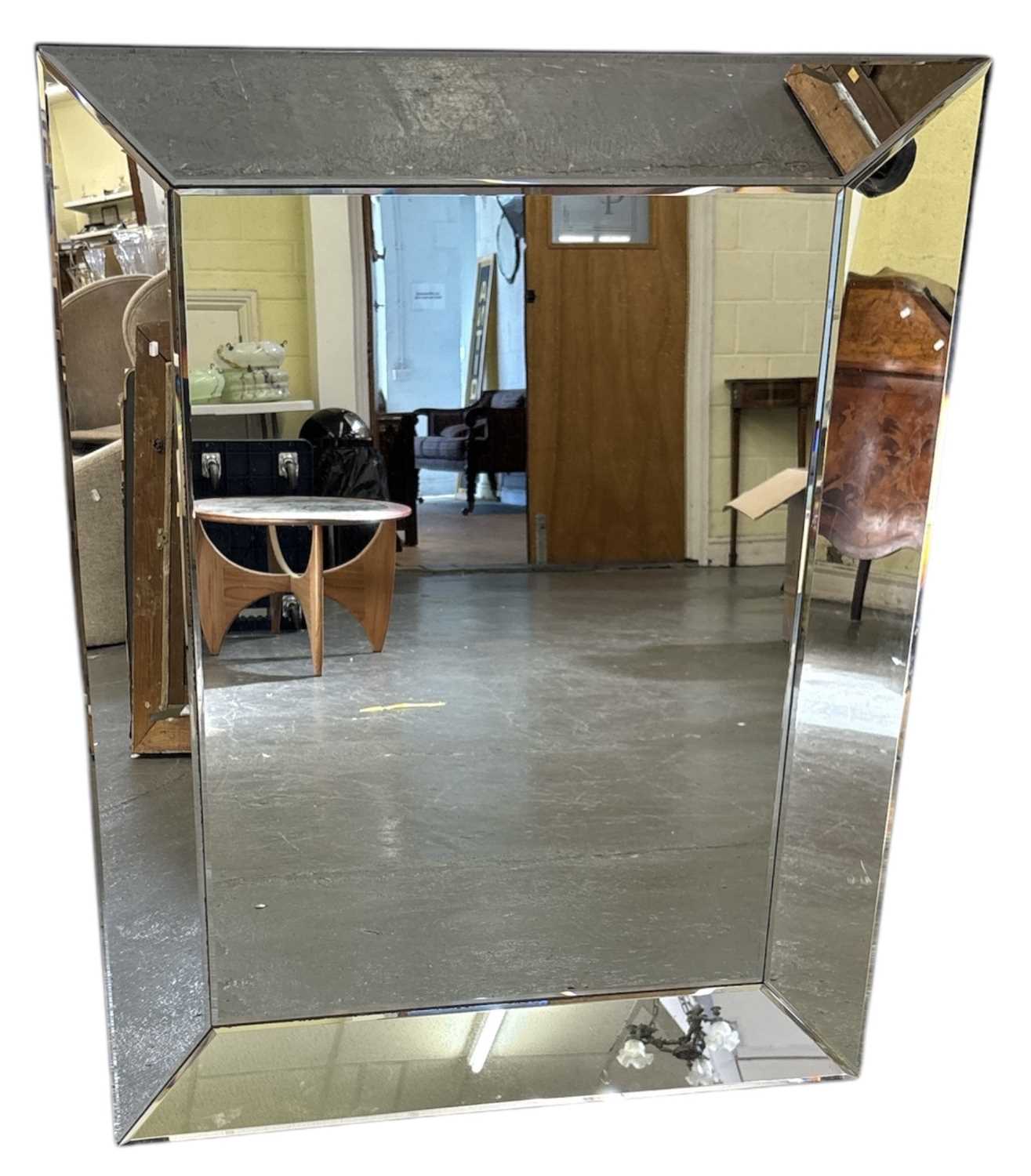 Lot 40 - A modern rectangular wall mirror with bevelled...